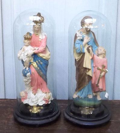 pair of old French religious statues in glass domes